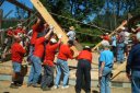 Volunteers raising the first framing beams of the Flumerfelt Barn